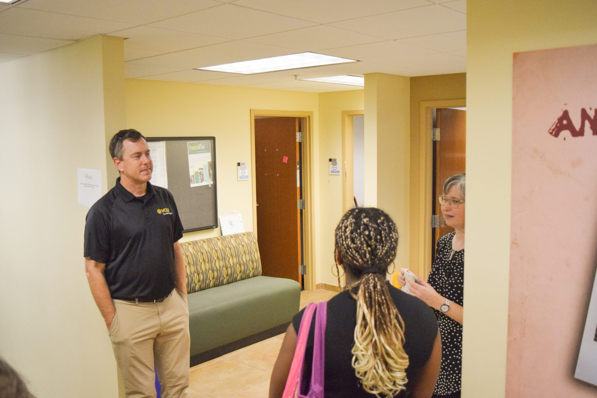 Division of Student Affairs staff in dialogue with a student.