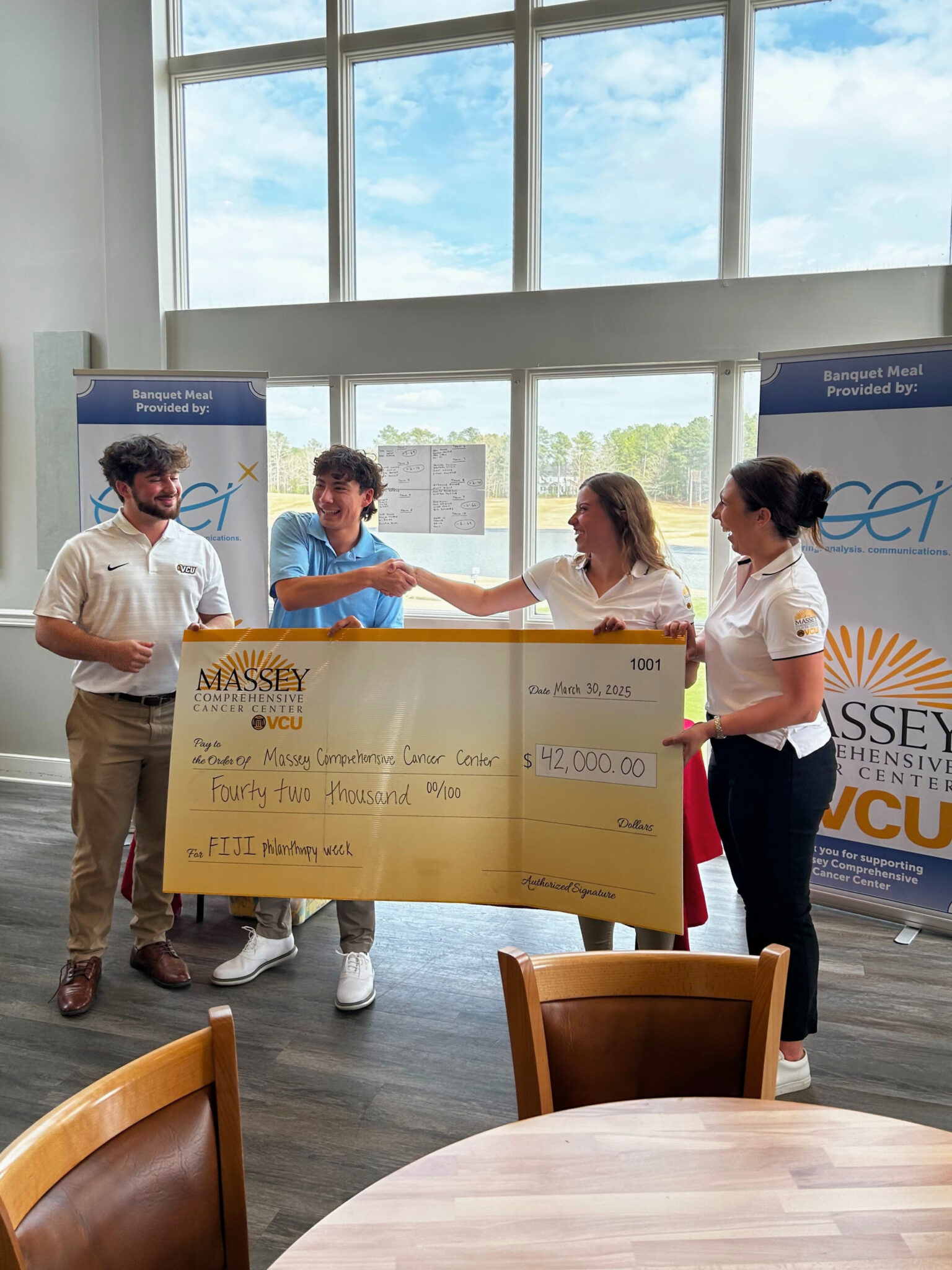 Members of Phi Gamma Delta Fraternity presenting check to the Massey Comprehensive Cancer Center team.
