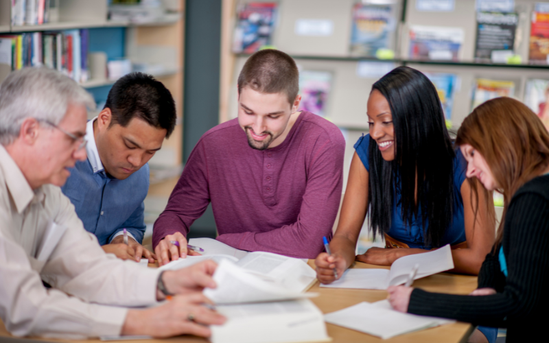 Group of teachers at a table conversing