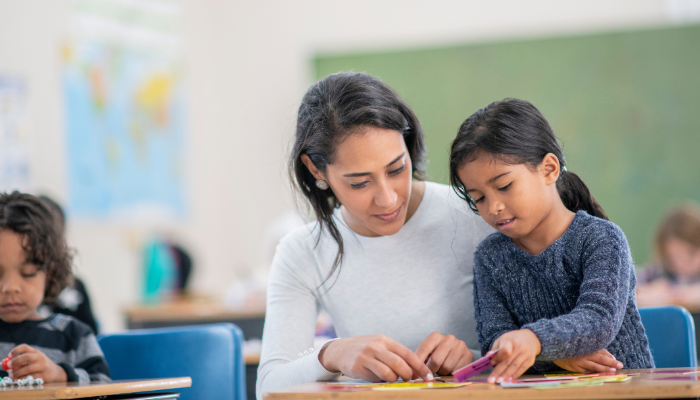 Image of teacher with young student.