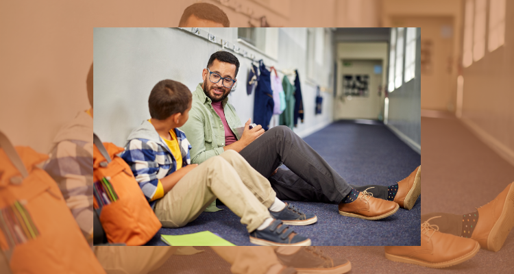 Image of a man and a boy sitting in a hallway talking