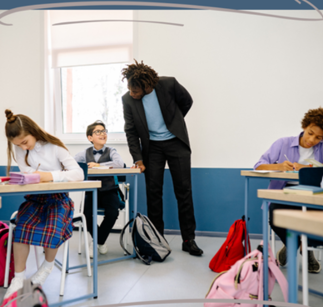 Image of a classroom with teacher engaging with student