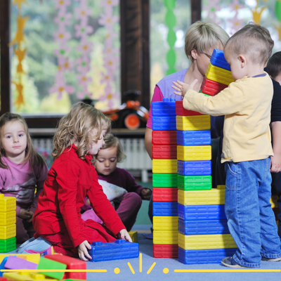 Photo of toddlers playing with building blocks