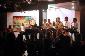 UKZN and VCU students perform with South African folk music legend Madala Kunene (left) under the direction of VCU Jazz Studies Director Antonio Garcia (center). (Photo credit Debbie Mari.)