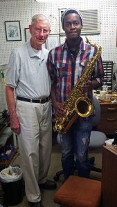 George Allan, instrument technician, with Linda Sikhakhane, whose horn Mr. Allan repaired.